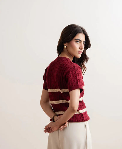 Red fitted knit top in side view, crew neck and short sleeves with cream striped bands