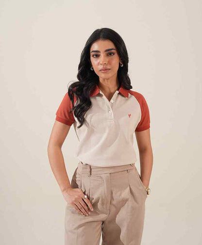 Fitted polo shirt with red sleeves and chest logo; khaki trousers with front pockets