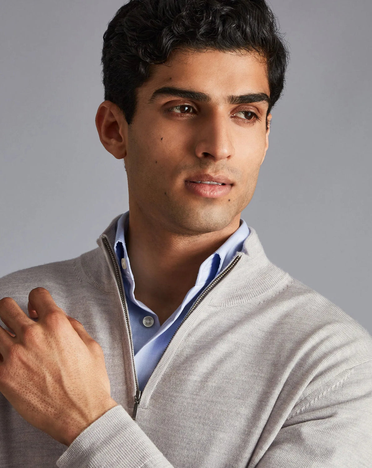 Men's grey quarter-zip knit sweater, close-up of collar and zip