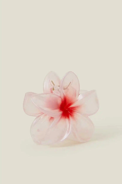 Pink flower hair clip with translucent petals, red center, and small pin