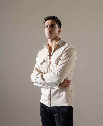 Men's beige fitted button-up shirt, three-quarter view with point collar and chest pockets