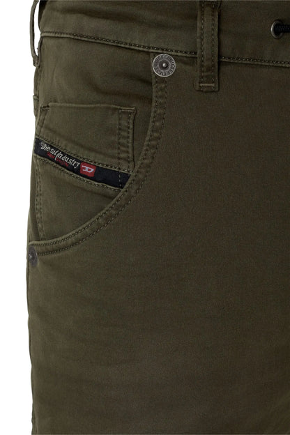 Olive green pants pocket with embroidered logo patch and metal button detail