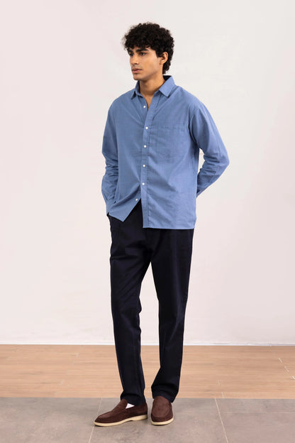 Men's blue long-sleeve button-up shirt with chest pocket and button-front closure