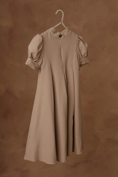 Stone dress on hanger with puff sleeves and gathered, flared skirt