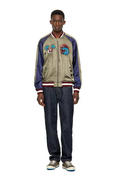 Diesel satin bomber jacket on model, olive front with dragon embroidery and navy sleeves