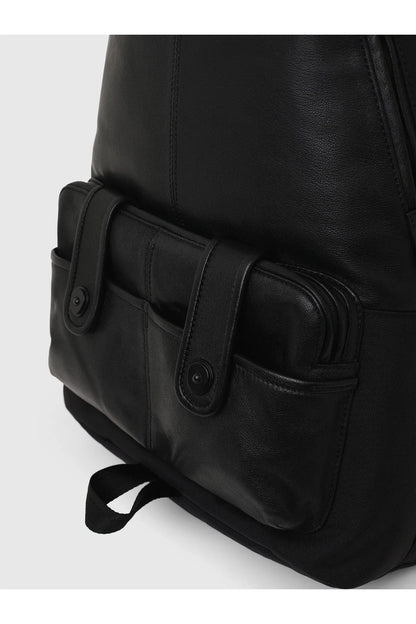 Black backpack side view with front gusset pocket and strap tabs