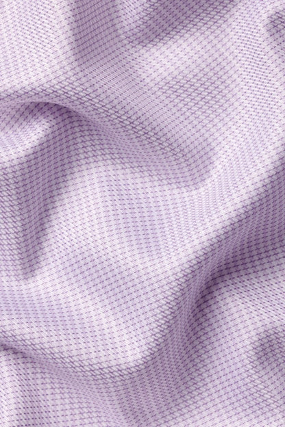 Purple dress shirt fabric texture close-up with stitched seam