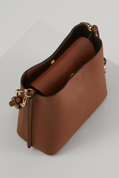 Brown leather handbag interior view with gold hardware at top and side strap