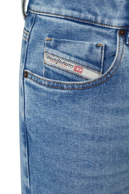 Light blue denim jeans pocket detail with branded patch and contrast stitching
