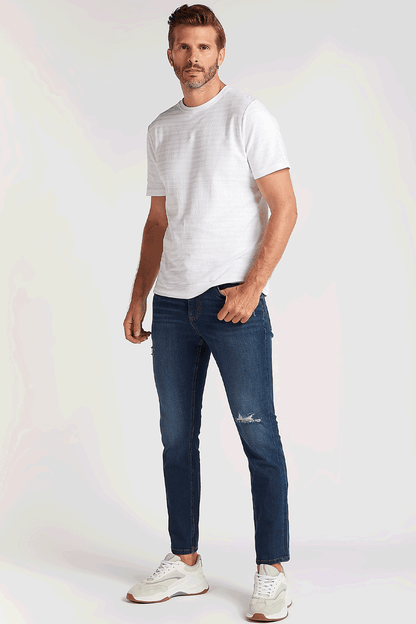 Men's dark blue denim jeans with knee distress, front view