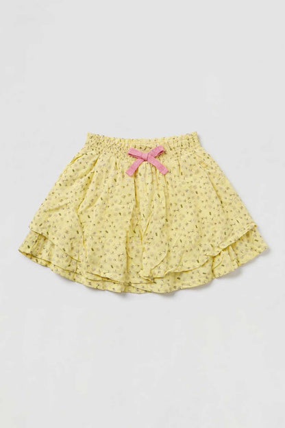 Yellow baby skirt with pink ribbon bow at waist, layered ruffled hem