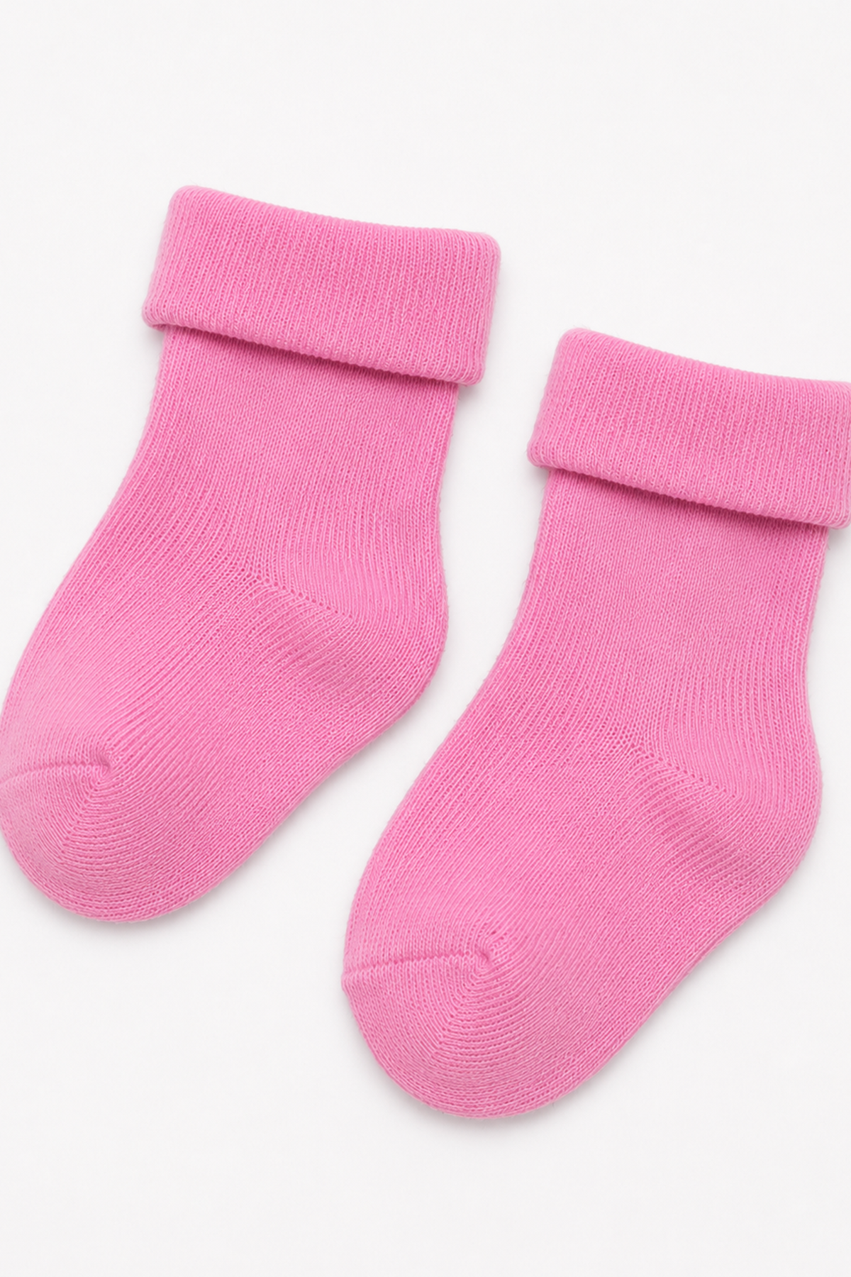 Pink knit baby socks with ribbed cuffs