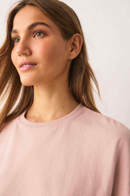 Pink short-sleeve T-shirt neckline and smooth fabric, close-up