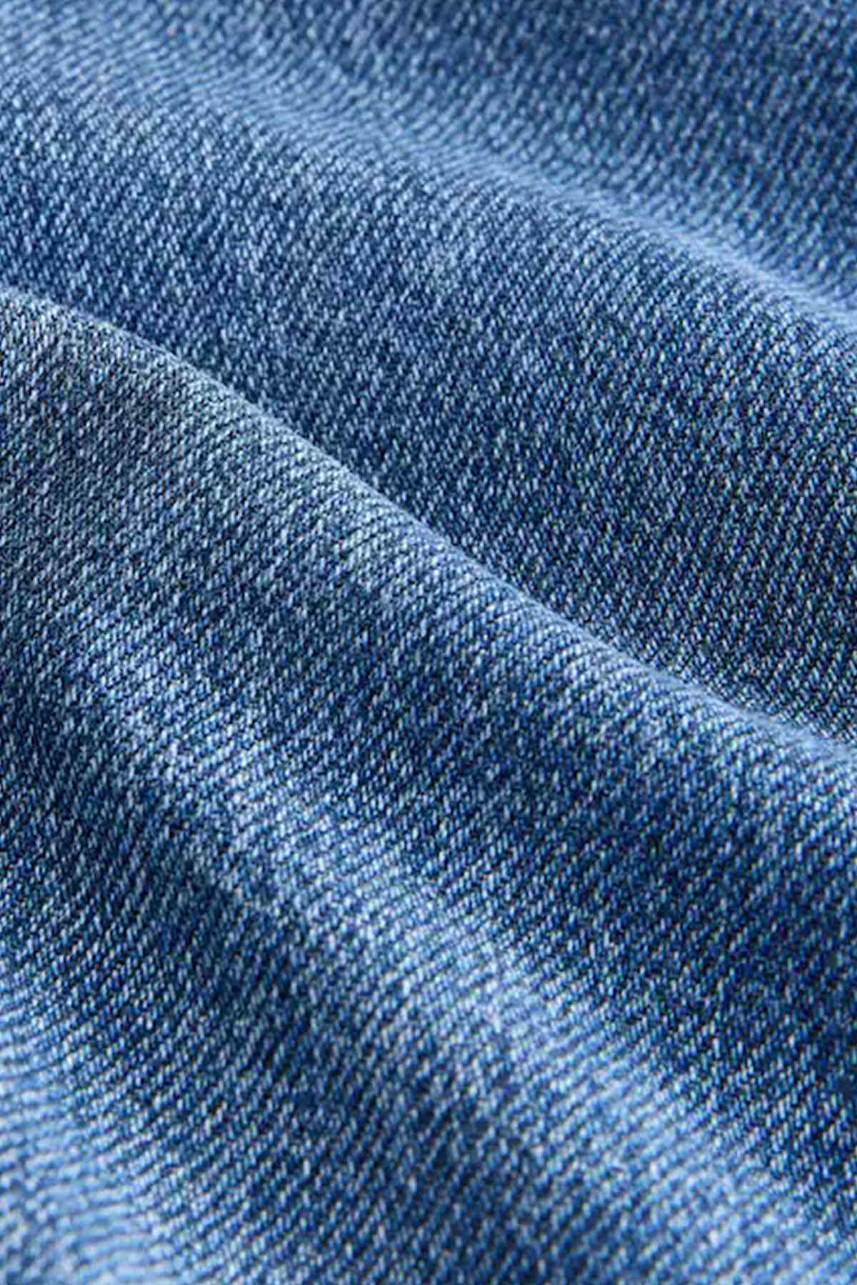 Blue denim fabric close-up showing woven texture
