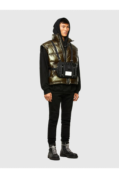 Metallic olive puffer vest with zip and stand collar worn with black jeans