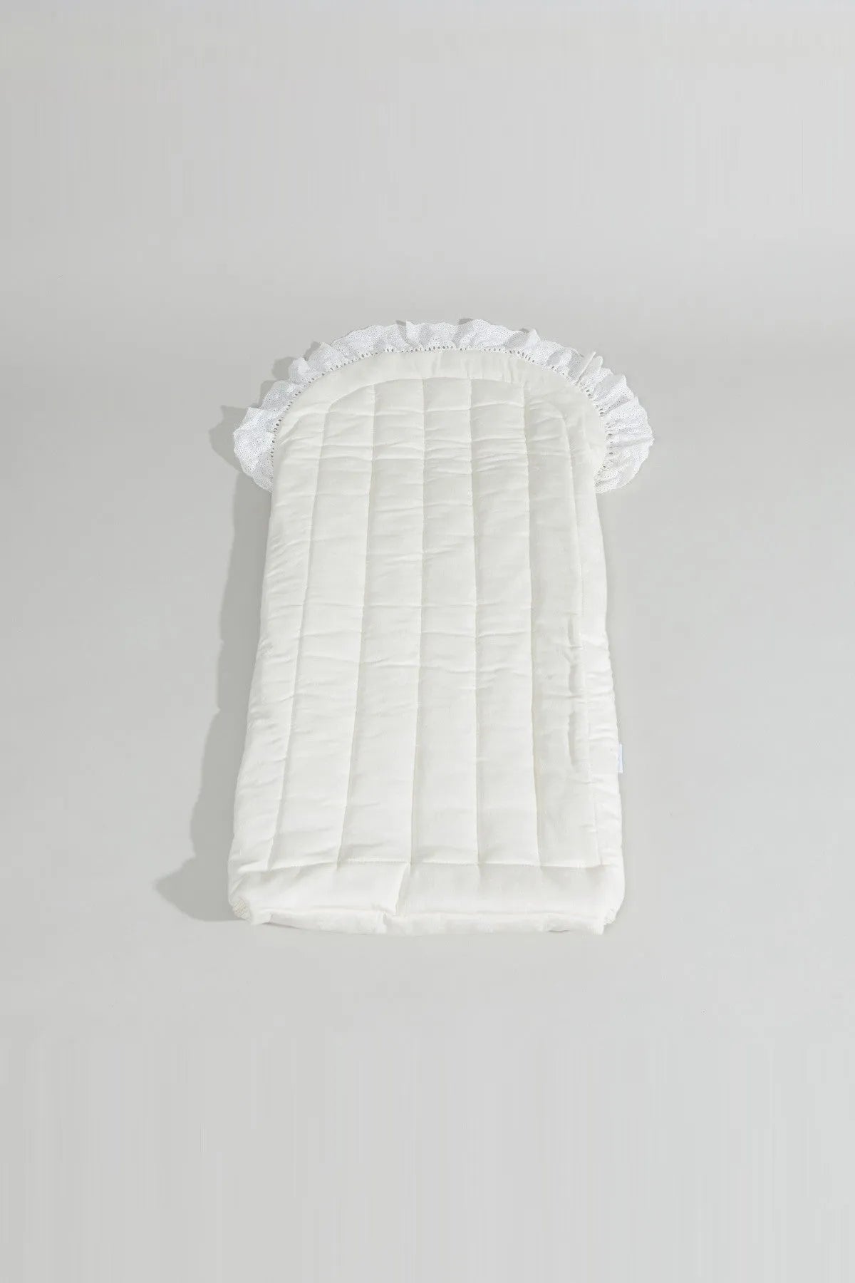 BABYSHOP cream newborn swaddle blanket with vertical quilting and ruffled border