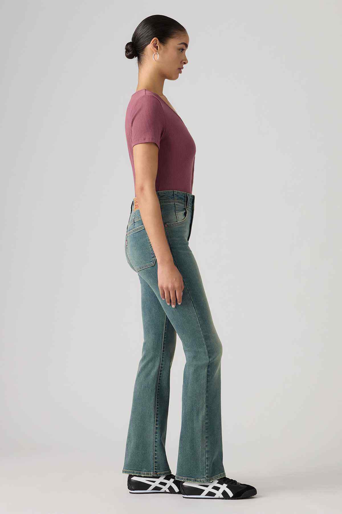 Levi's mid-indigo bootcut jeans side view with flared hem and classic seams