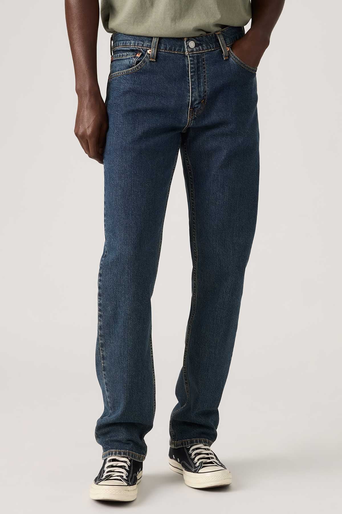 Dark blue denim jeans close-up with button-fly, belt loops, and stitched seams
