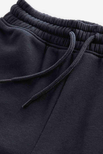 Dark navy drawstring waistband detail with elastic ribbing and seam stitching