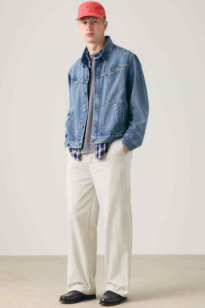 Levi's blue denim jacket over beige pants and red cap