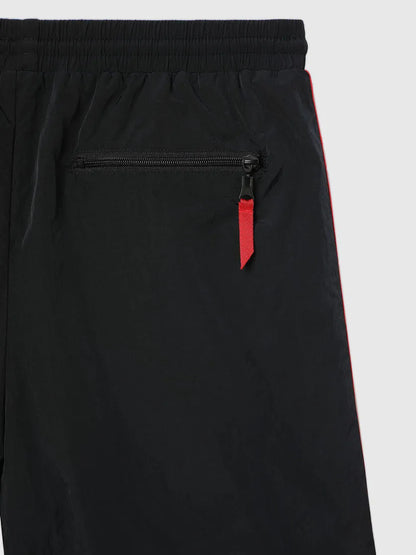 Black shorts detail: side zip pocket with red pull, drawstring waistband and red stripe
