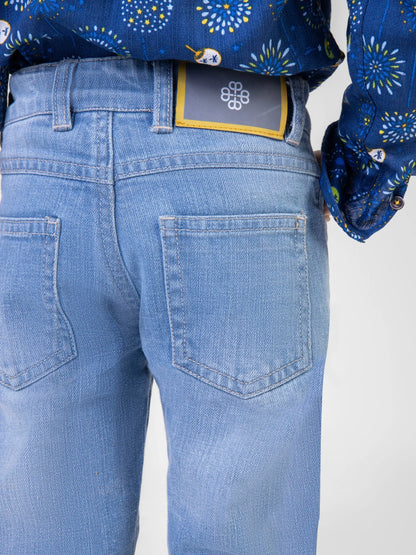 Blue denim jeans close-up with stitched back pockets and waistband label