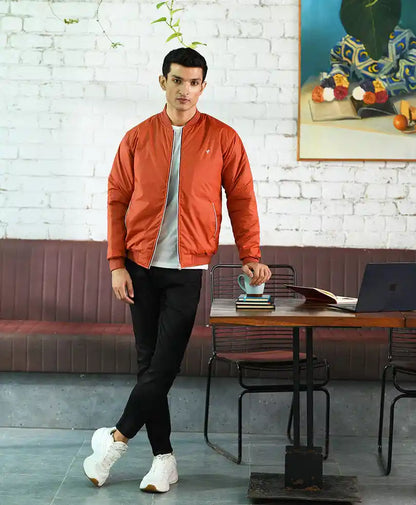 Rust-orange bomber jacket with zip front, ribbed cuffs, and stand collar