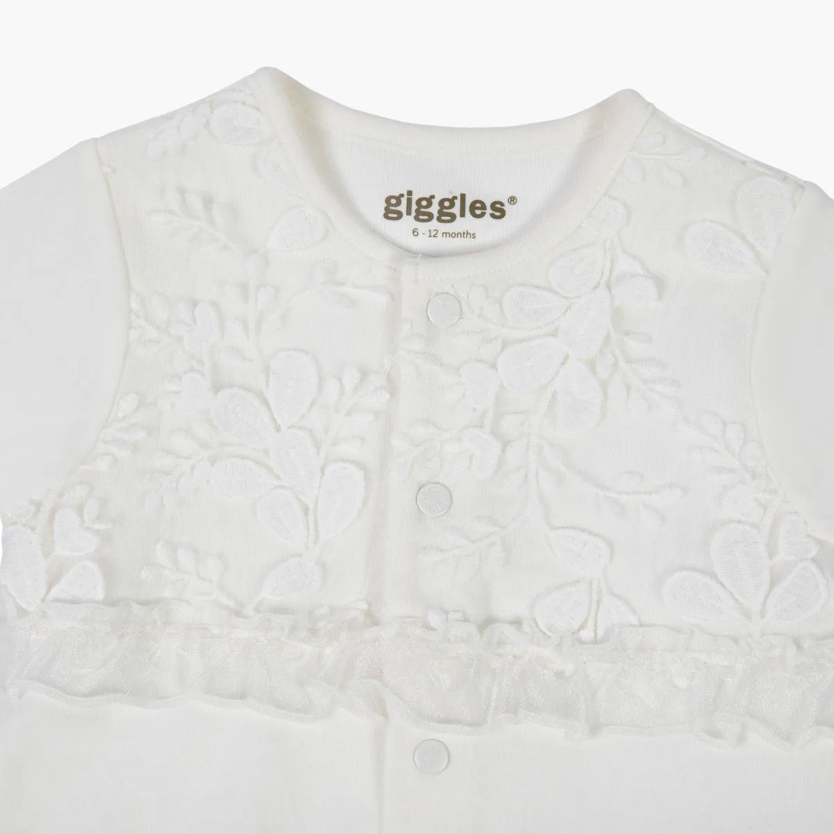 Cream baby romper with textured floral pattern, front snaps, giggles® logo