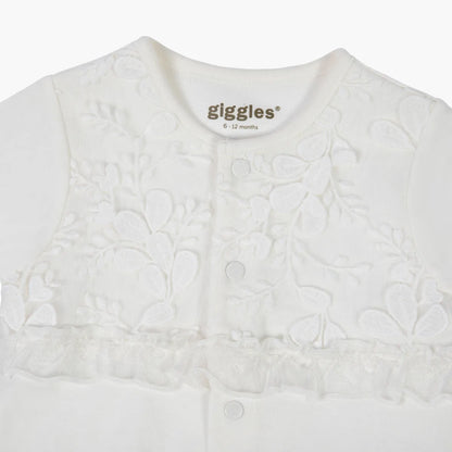 Cream baby romper with textured floral pattern, front snaps, giggles® logo