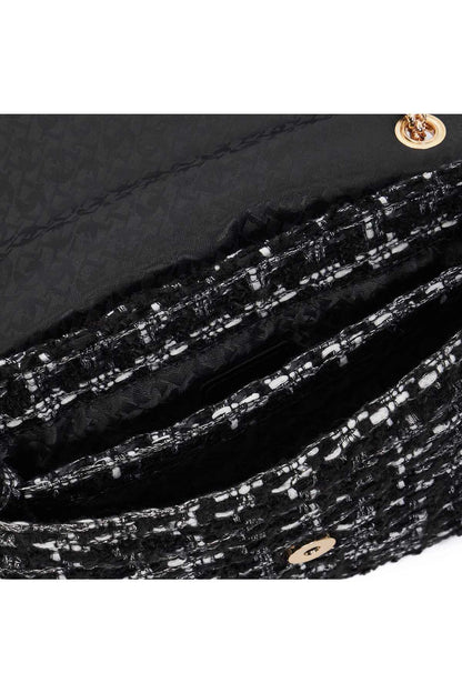 Black tweed handbag lining with white fleck texture and gold-tone logo tab