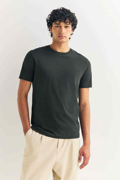 Olive green crewneck short-sleeve T-shirt on model, straight hem