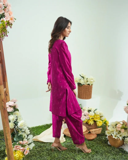 Magenta long-sleeve tunic and pants set with dotted pattern, standing side view