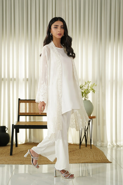 White embroidered long kurta set with lace-trim hem and straight pants, side view