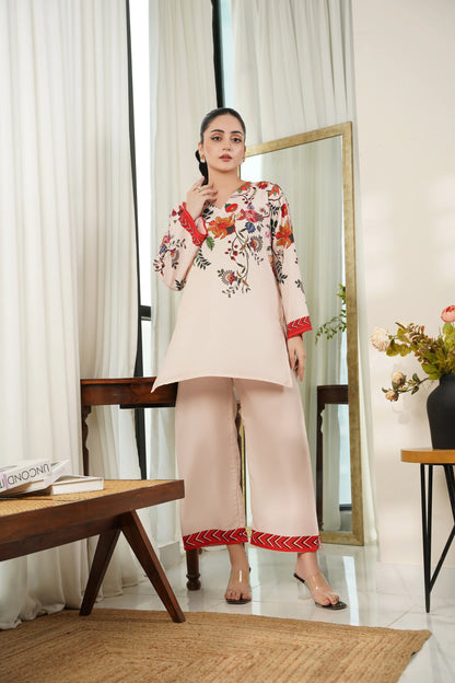 Off-white floral tunic with red accents and matching beige pants