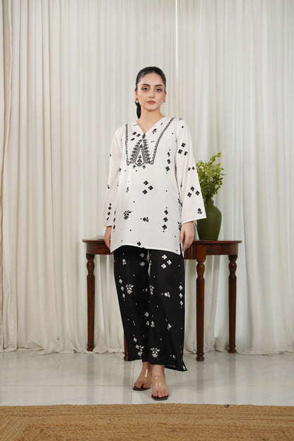 White V-neck printed kurta with black motifs and black printed palazzo pants
