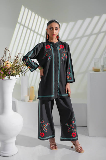 Black embroidered tunic and straight pants set with red floral accents and teal trim