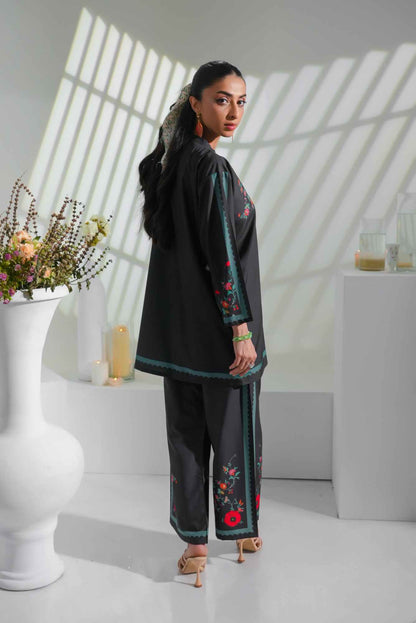 Black embroidered tunic and pants set with red floral motifs and teal border trim