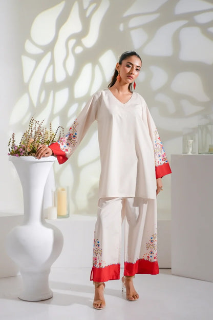 Dhaga white kurta with floral arm panels, red hem, and loose pajama trousers