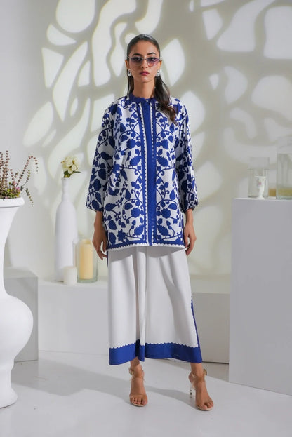 Blue-and-white printed long kurta with long sleeves and white pants with blue hem band