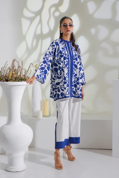 Blue-and-white printed tunic with long sleeves and white pants featuring a blue lower border