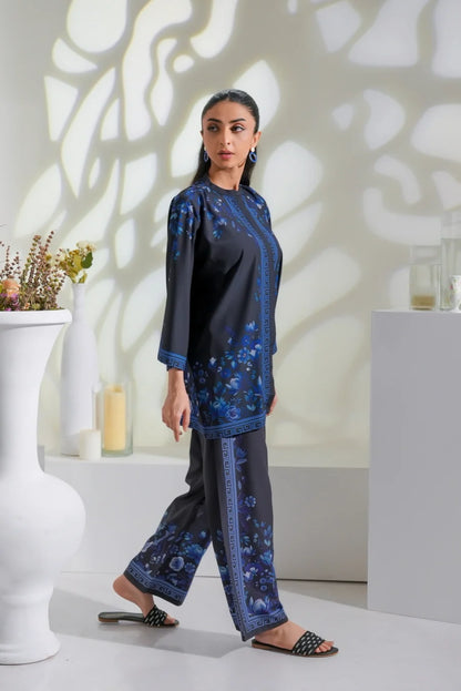 Women's dark printed kurta with blue detailing and matching wide-leg pants