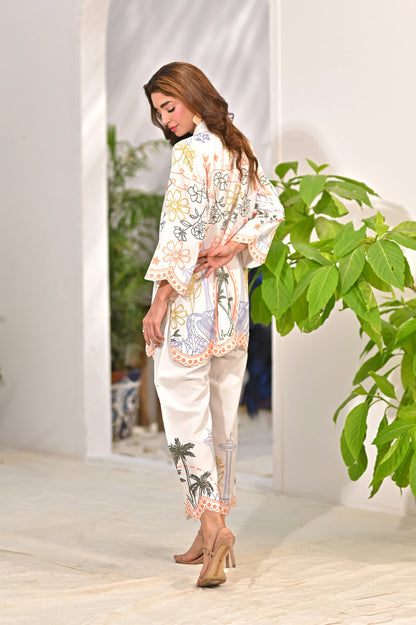 Women’s printed kurta and pants set, white with multicolor border trim, shown from side