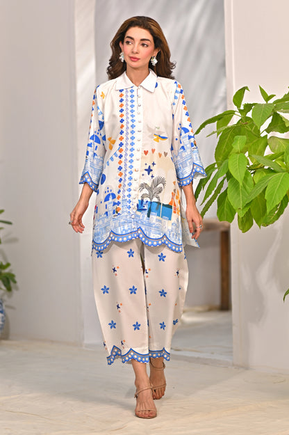 Women’s printed kurta pajama set, off-white with blue border and colorful motifs