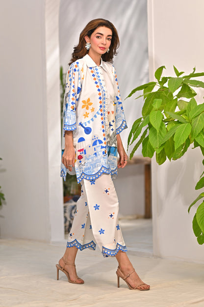Women’s printed kurta pajama set, off-white with blue trim and colorful motifs