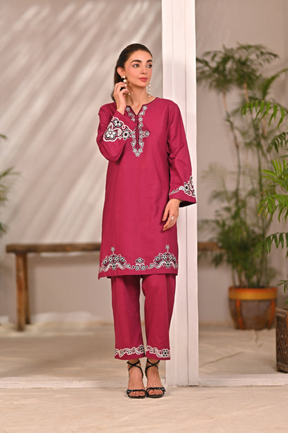 Women’s magenta embroidered kurta and pants set with white trim at neckline and hem