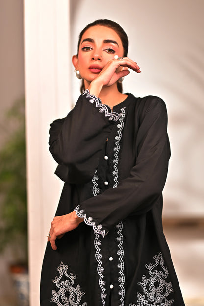 Women’s black embroidered tunic with floral motifs and scalloped cuffs