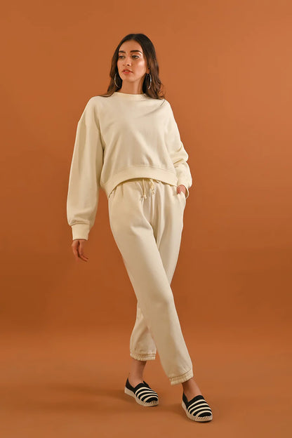 Cream sweatshirt and jogger pants set with drawstring waist and cuffed hems