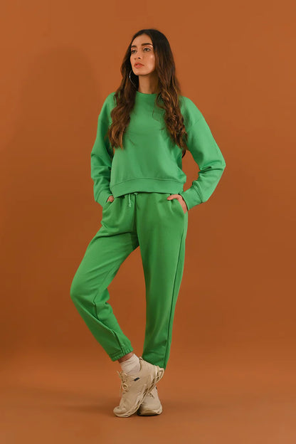 Green jogger pants and sweatshirt set with drawstring waist, side pose with sneakers