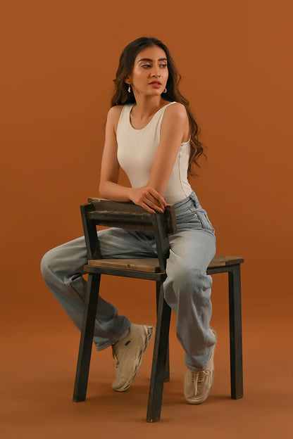 White sleeveless tank top with round neckline, fitted silhouette and side seams