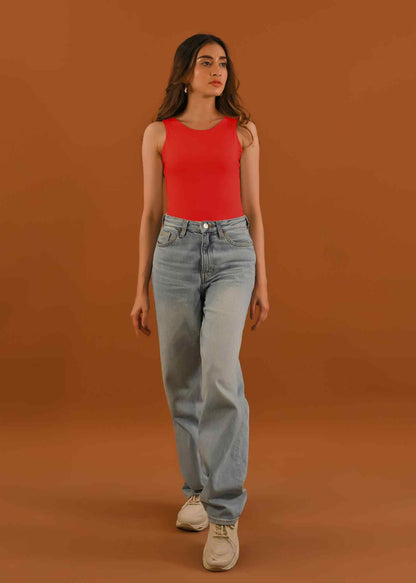 Dhaga red sleeveless tank top with light-wash straight jeans and sneakers